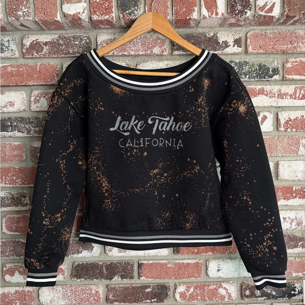 Lake Tahoe CA Bleach splatter crewneck sweatshirt w/striped varsity ribbed trim.